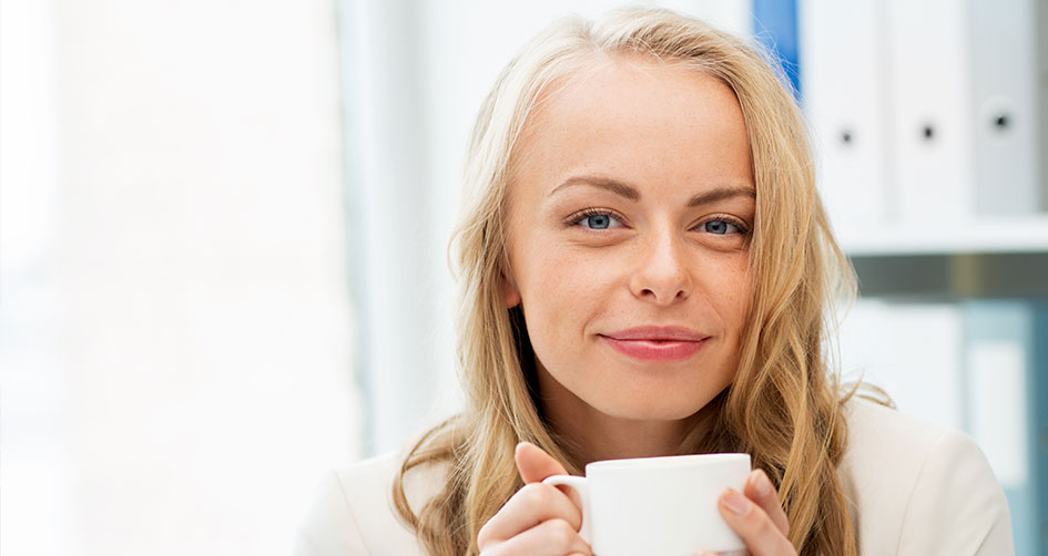 Woman drinking a hot coffee