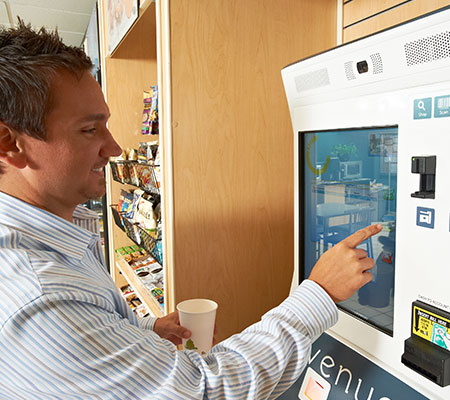 Employee using the easy cashless vending system in his breakroom
